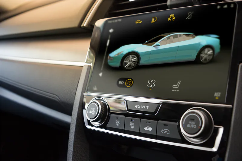 Car dashboard touchscreen showing a vehicle model and climate icons above physical knobs and buttons