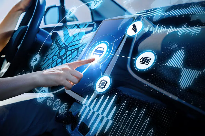 Driver's hand touching a car infotainment touchscreen surrounded by holographic icons