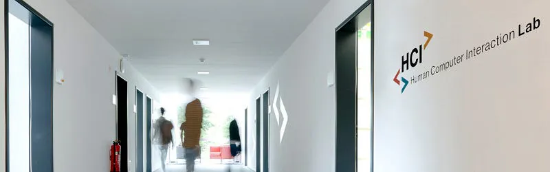 Corridor of the Saarland University Human Computer Interaction Lab with the HCI Lab logo on the wall