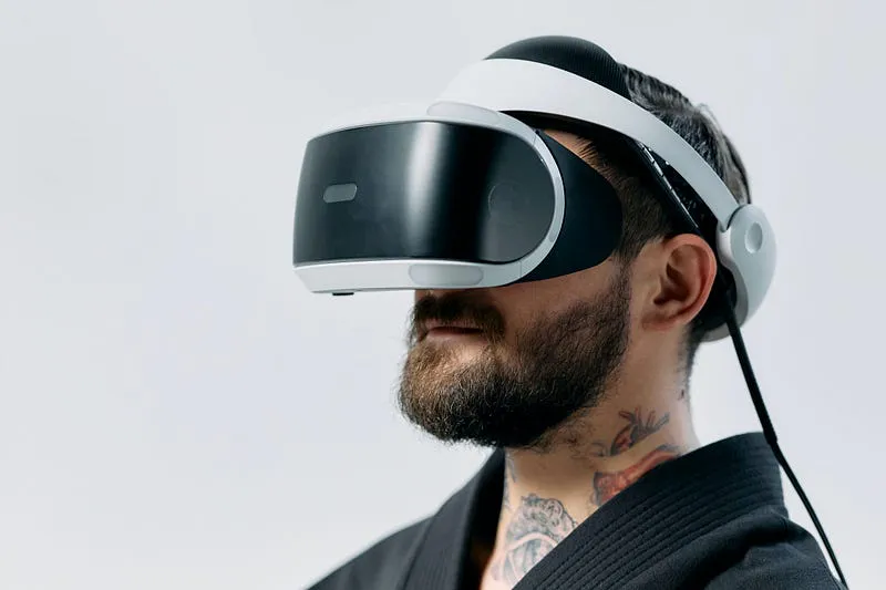 Man wearing a white VR headset, illustrating haptics for VR experiences and locomotion